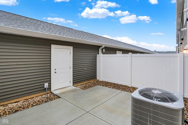 exterior space featuring cooling unit and fence