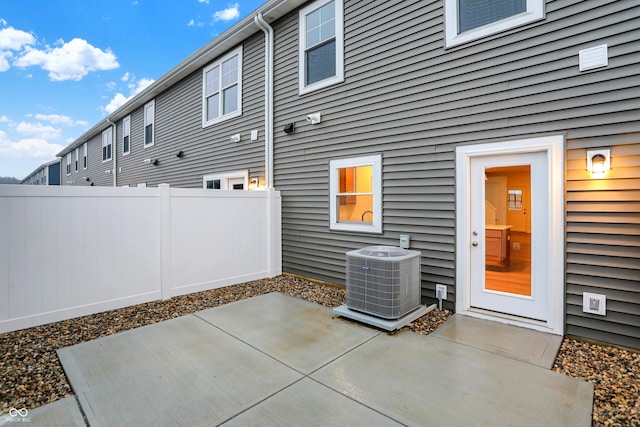 view of patio / terrace with central AC unit and fence