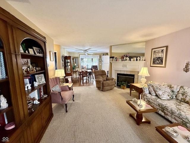 living room with ceiling fan, carpet, and a fireplace