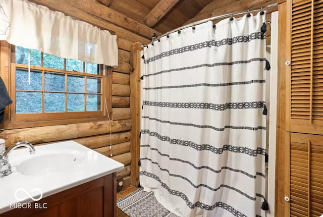 full bath with rustic walls, a shower with curtain, and vanity