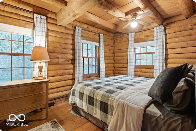 bedroom featuring beamed ceiling, wood ceiling, and hardwood / wood-style flooring