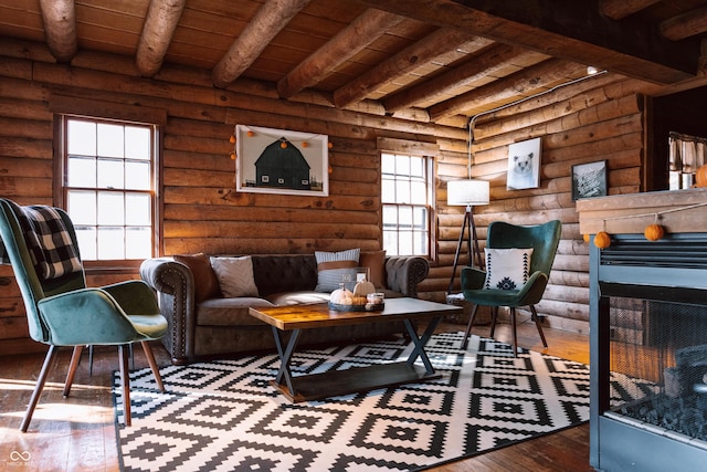 living area featuring beamed ceiling, wood ceiling, wood-type flooring, and rustic walls