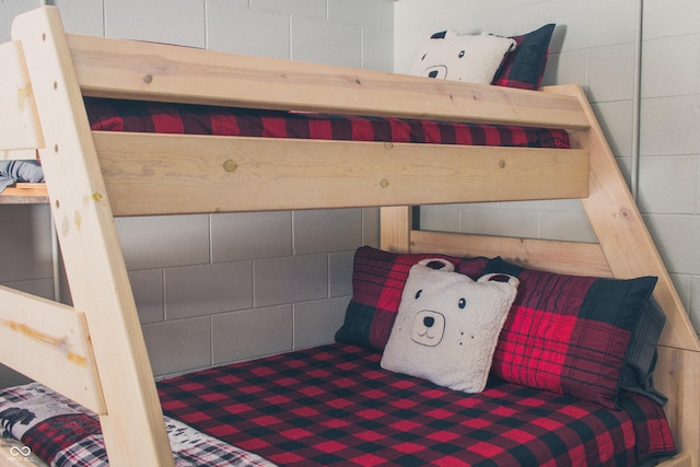 bedroom with concrete block wall