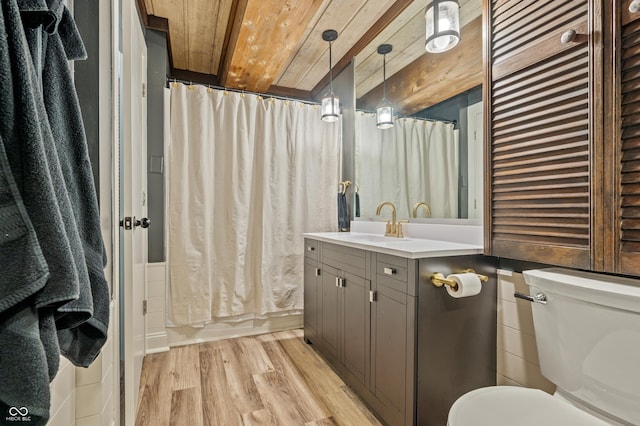 bathroom with toilet, wood ceiling, wood finished floors, and vanity