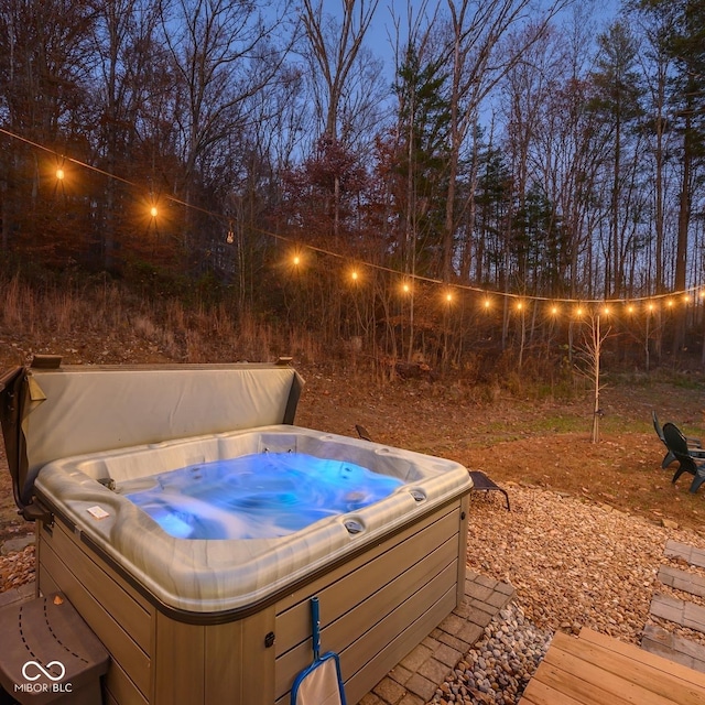 view of swimming pool featuring a hot tub