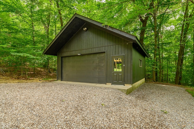 detached garage featuring a wooded view