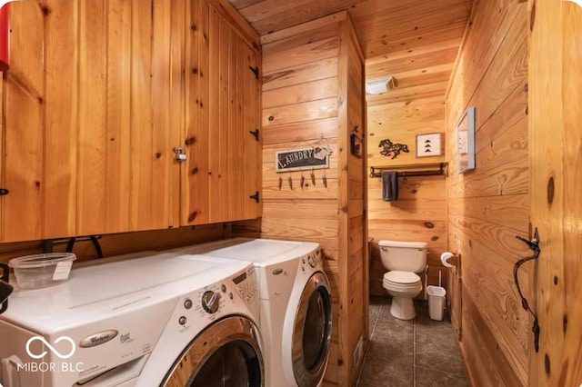 laundry area with washing machine and dryer, wooden ceiling, wood walls, tile patterned flooring, and laundry area