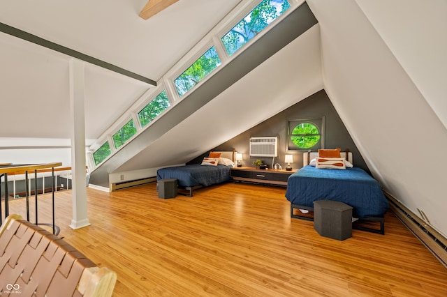 bedroom with light wood finished floors, a baseboard radiator, lofted ceiling with skylight, and a wall mounted AC