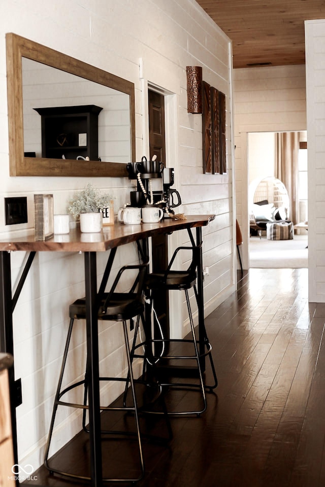 dining room featuring dark wood finished floors and wood ceiling