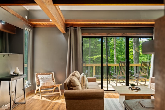 interior space with beam ceiling and wood finished floors