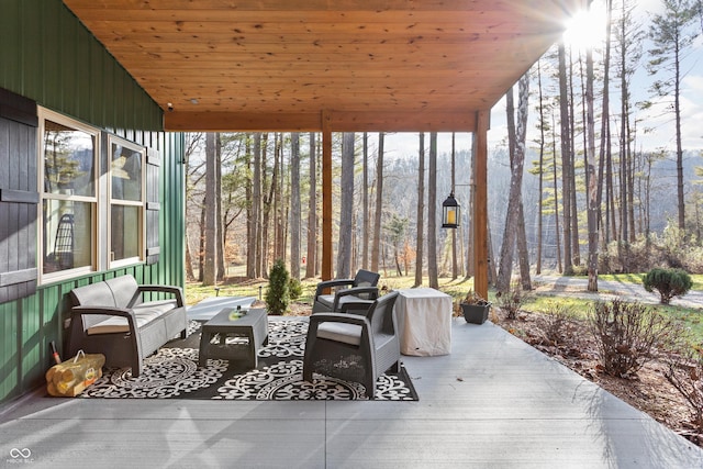 sunroom / solarium featuring wood ceiling