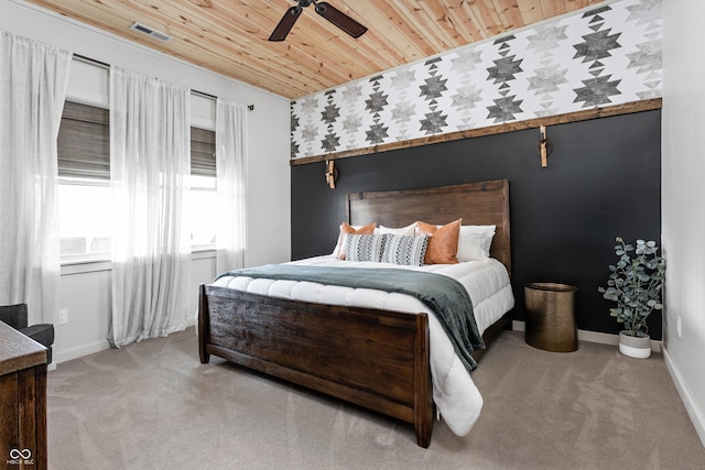 carpeted bedroom with wooden ceiling, visible vents, baseboards, and ceiling fan