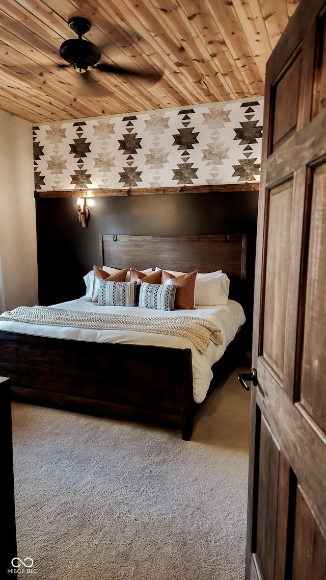 unfurnished bedroom featuring wooden ceiling, carpet flooring, and wallpapered walls