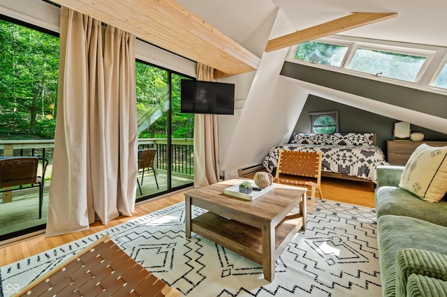 living room with baseboard heating, lofted ceiling with beams, and wood finished floors