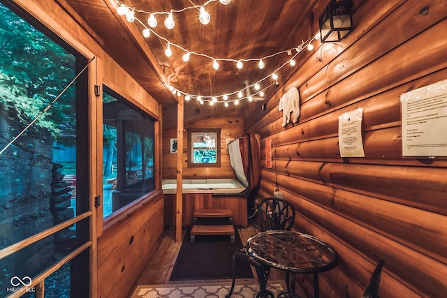 interior space with wood finished floors and log walls