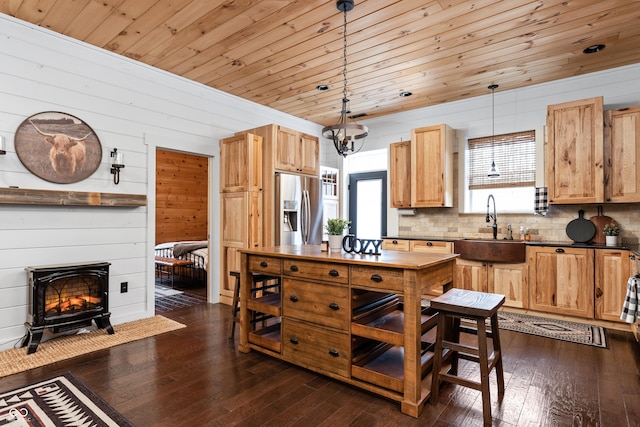 kitchen featuring dark wood finished floors, wood ceiling, stainless steel fridge with ice dispenser, and a sink