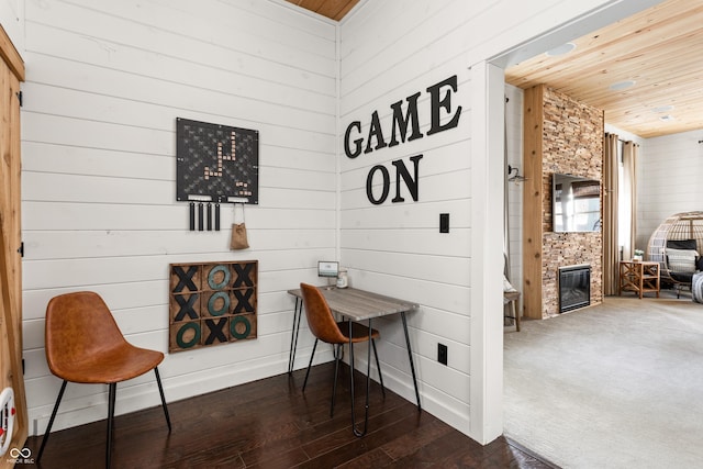 living area featuring wood ceiling and dark wood-type flooring