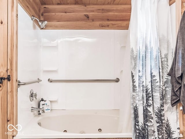 bathroom featuring wooden ceiling, beamed ceiling, and a combined bath / shower with jetted tub