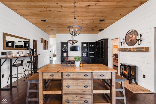 dining room with a chandelier, wooden ceiling, and dark wood finished floors