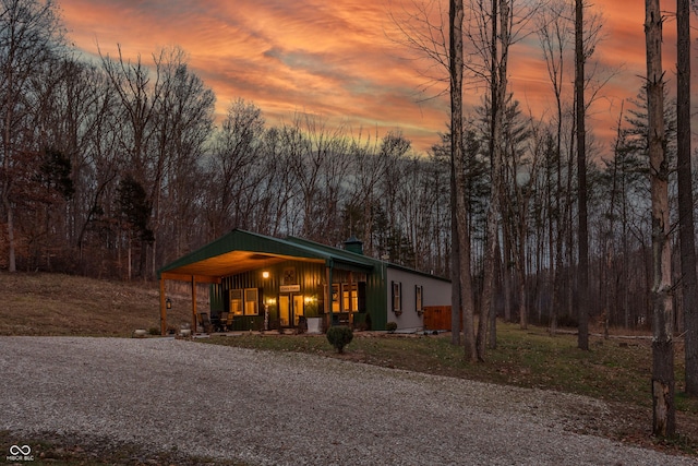 view of front of house with a porch, a carport, and driveway