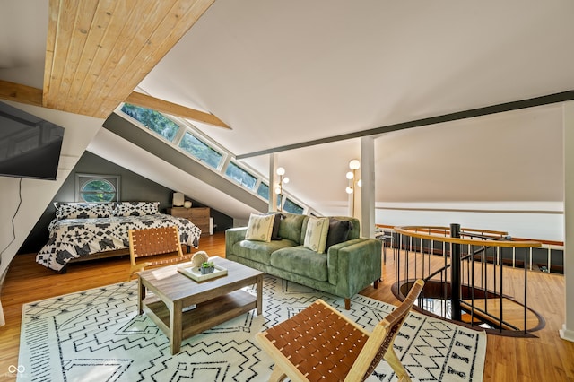 living room featuring lofted ceiling with skylight and wood finished floors