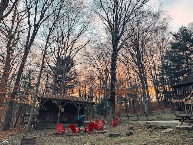 yard at dusk with an outbuilding and an outdoor structure