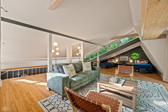 living area with lofted ceiling with beams and wood finished floors