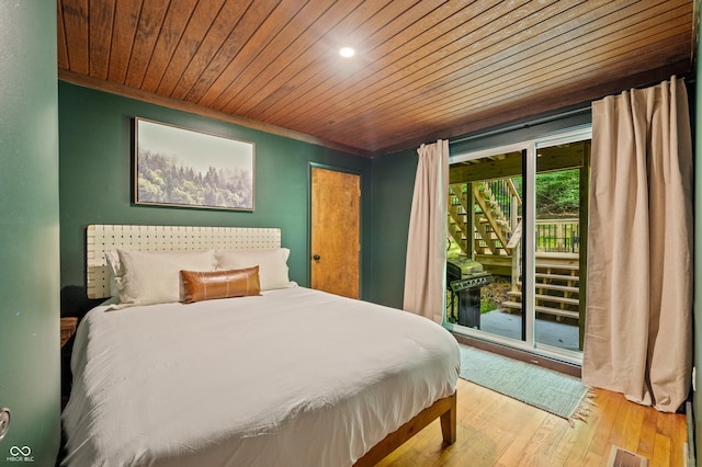 bedroom with access to exterior, visible vents, wooden ceiling, and wood finished floors