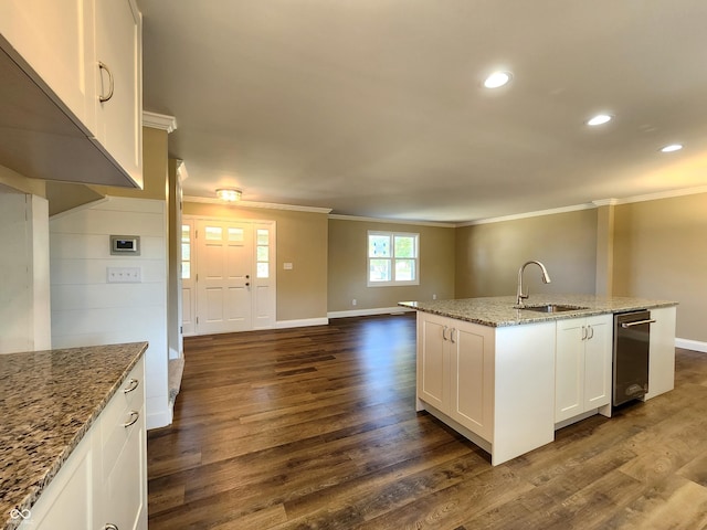 kitchen featuring dark wood-style floors, ornamental molding, open floor plan, and a sink