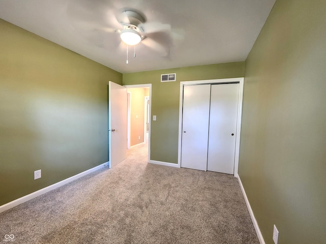 unfurnished bedroom featuring baseboards, visible vents, and carpet flooring