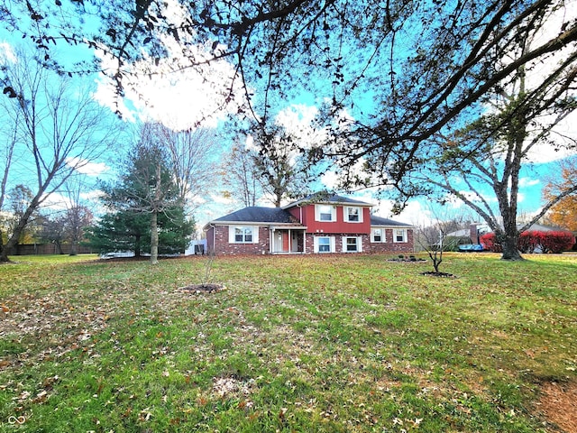 view of front of property with a front lawn and brick siding