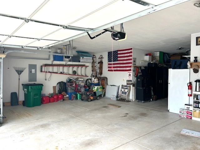 936 Plunkett Ave, Westfield, IN 46074 - garage featuring electric panel, freestanding refrigerator, and a garage door opener