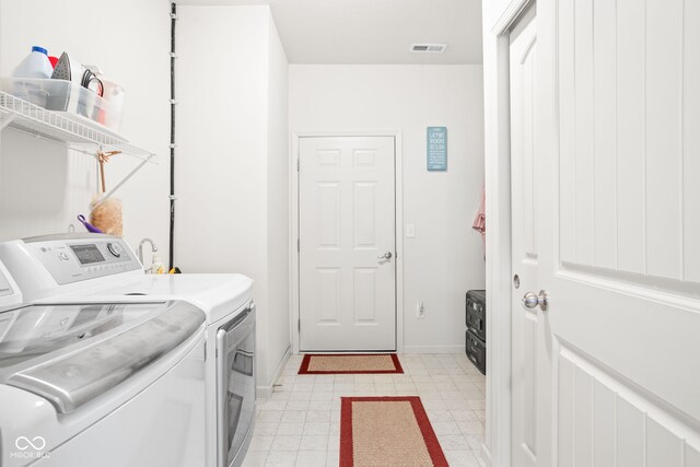 936 Plunkett Ave, Westfield, IN 46074 - washroom with washing machine and clothes dryer and light flooring