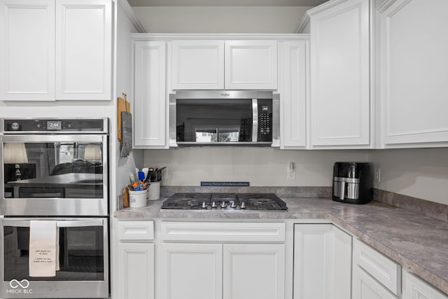 936 Plunkett Ave, Westfield, IN 46074 - kitchen with appliances with stainless steel finishes, white cabinetry, and light countertops
