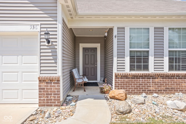 936 Plunkett Ave, Westfield, IN 46074 - view of exterior entry featuring brick siding and a garage