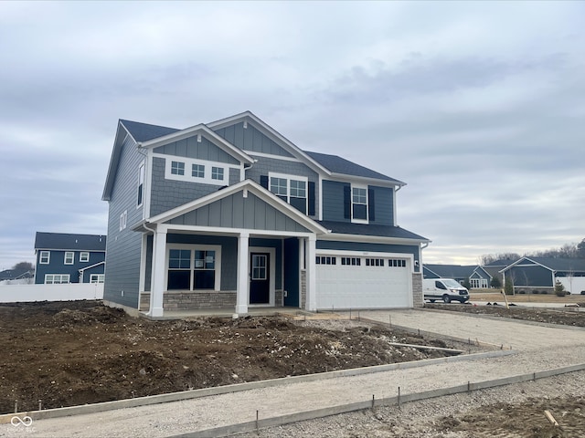 view of front of property with a porch, board and batten siding, concrete driveway, and an attached garage