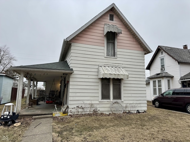 exterior space with roof with shingles