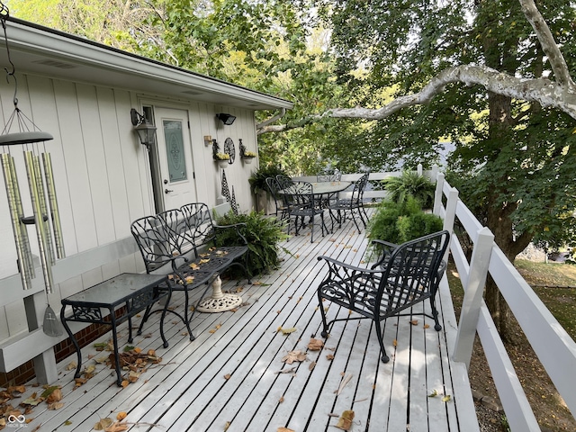 wooden deck featuring outdoor dining space