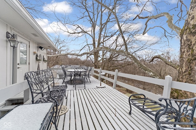 wooden terrace featuring outdoor dining area and fence