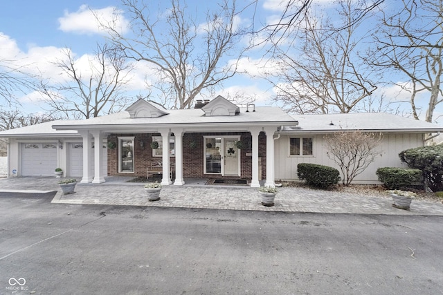 view of front of house featuring an attached garage and brick siding