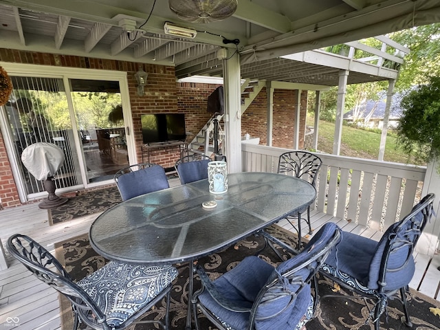 deck with outdoor dining area and ceiling fan