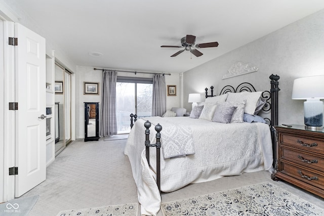 bedroom with access to exterior, light carpet, and a ceiling fan