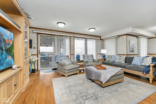 living area with light wood finished floors and ornamental molding