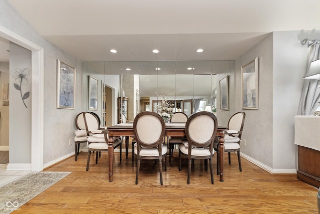 dining area with light wood-style flooring, recessed lighting, and baseboards