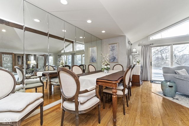 dining space with light wood finished floors, recessed lighting, and lofted ceiling