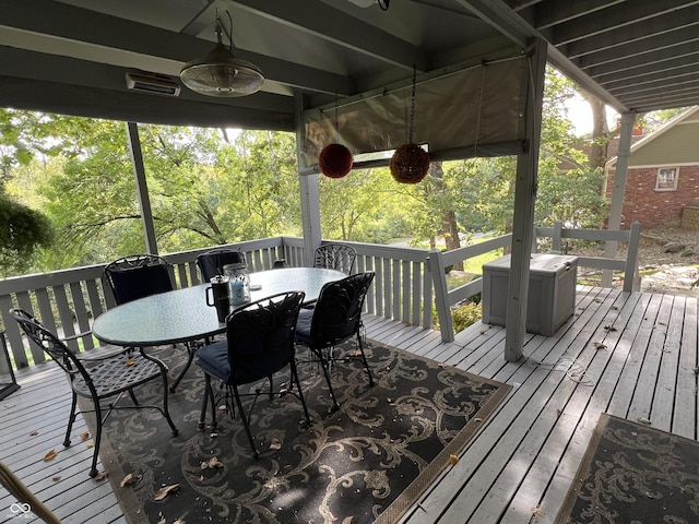 deck with outdoor dining area and ceiling fan