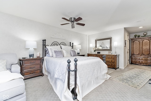 bedroom with light carpet and a ceiling fan