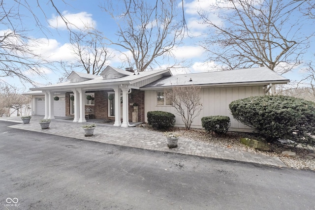 view of front of property featuring brick siding and an attached garage