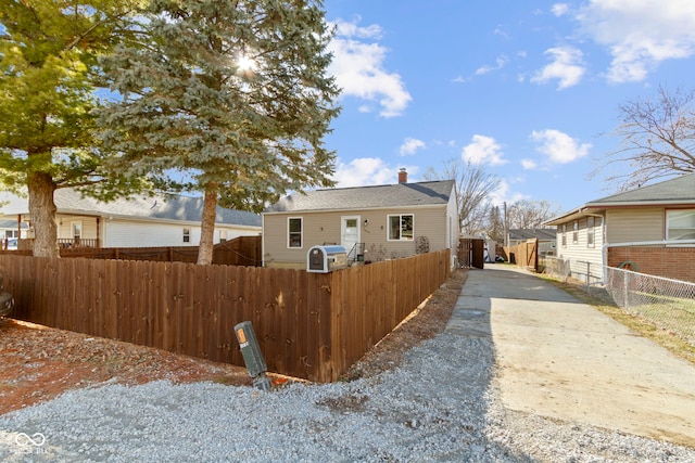 rear view of house featuring fence private yard and a chimney