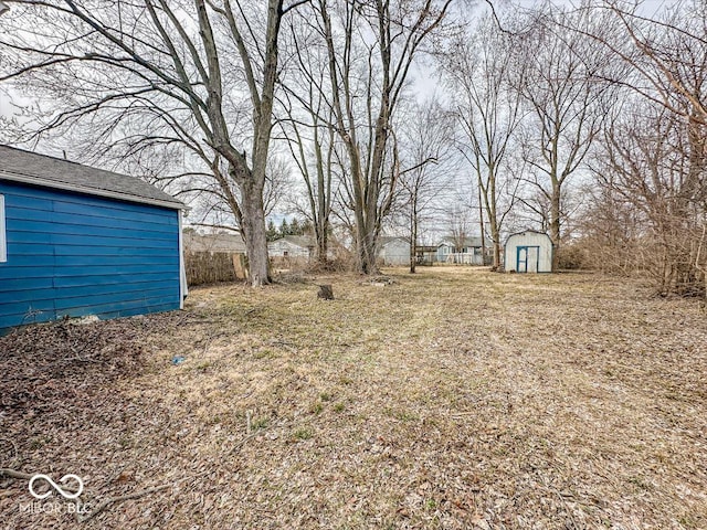 view of yard with an outbuilding and a storage shed